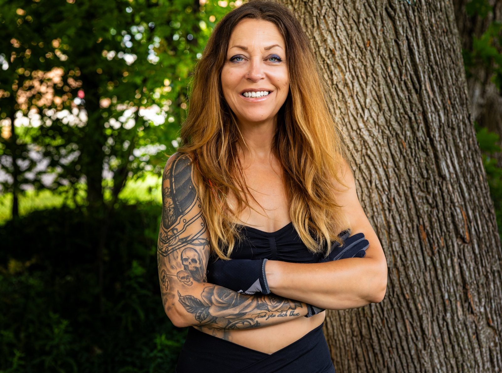 Lisa Marchesani, personal trainer, standing outdoors with arms crossed